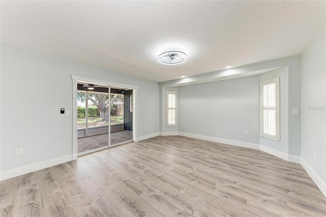 3330 46th Ter E, Bradenton, FL 34203 - unfurnished room with a textured ceiling, wood finished floors, baseboards, and recessed lighting