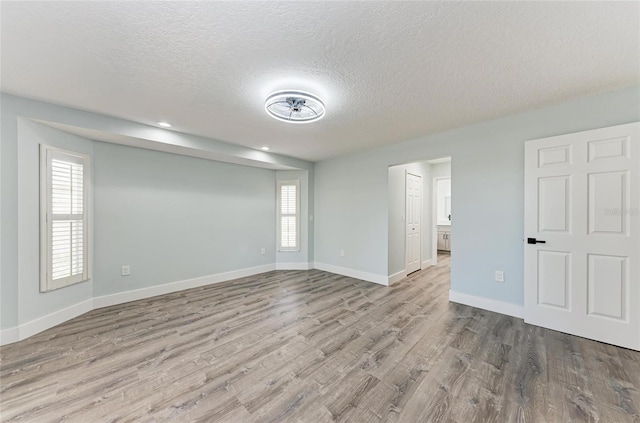 3330 46th Ter E, Bradenton, FL 34203 - unfurnished room with wood finished floors, a textured ceiling, baseboards, and recessed lighting