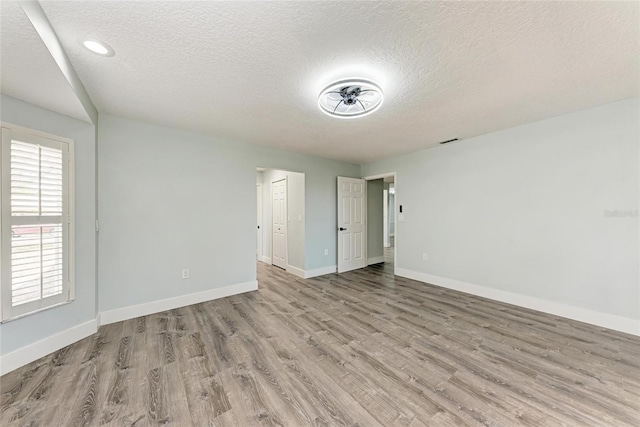 3330 46th Ter E, Bradenton, FL 34203 - empty room with wood finished floors, baseboards, and a textured ceiling