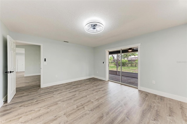 3330 46th Ter E, Bradenton, FL 34203 - spare room with a textured ceiling, light wood-type flooring, and baseboards