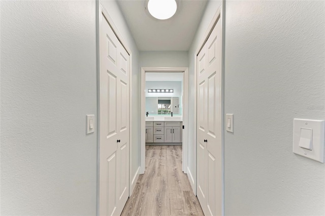 3330 46th Ter E, Bradenton, FL 34203 - hallway featuring light wood finished floors and a textured wall