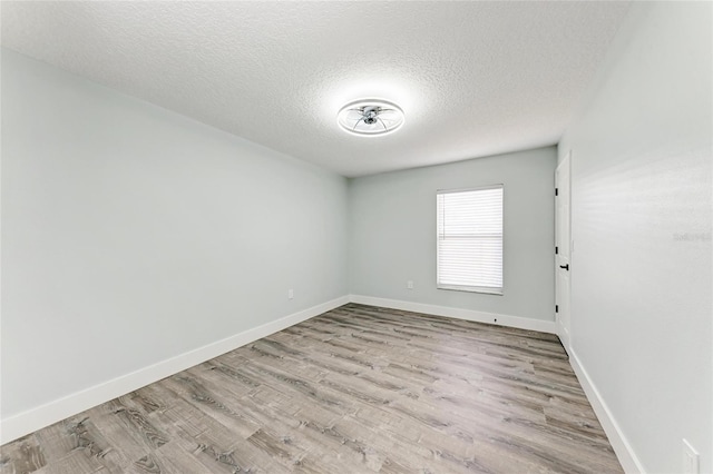 3330 46th Ter E, Bradenton, FL 34203 - unfurnished room with a textured ceiling, wood finished floors, and baseboards