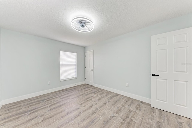 3330 46th Ter E, Bradenton, FL 34203 - spare room featuring light wood-style flooring, a textured ceiling, and baseboards