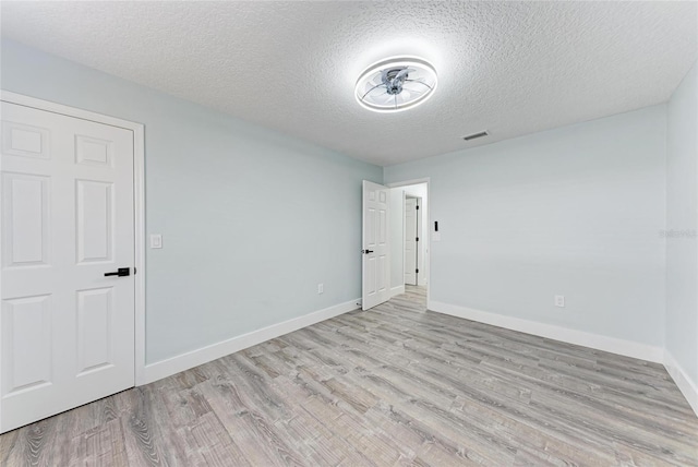 3330 46th Ter E, Bradenton, FL 34203 - unfurnished room featuring wood finished floors, a textured ceiling, and baseboards