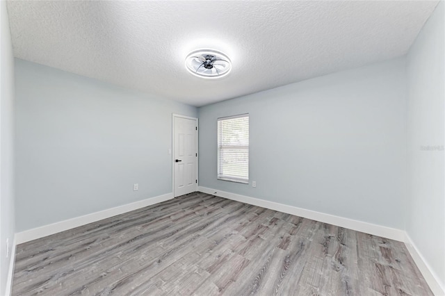 3330 46th Ter E, Bradenton, FL 34203 - spare room with wood finished floors, a textured ceiling, and baseboards