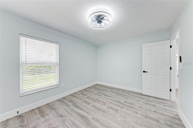 3330 46th Ter E, Bradenton, FL 34203 - unfurnished room featuring a textured ceiling, light wood-style flooring, and baseboards