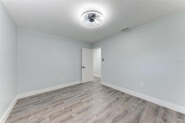 3330 46th Ter E, Bradenton, FL 34203 - unfurnished room featuring a textured ceiling, wood finished floors, and baseboards