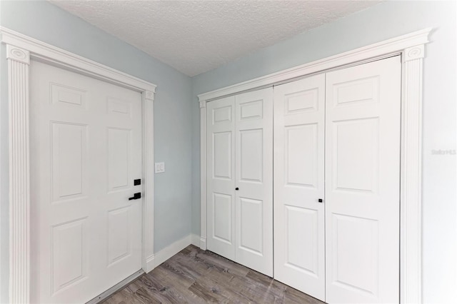3330 46th Ter E, Bradenton, FL 34203 - foyer entrance with dark wood-style floors, a textured ceiling, and baseboards