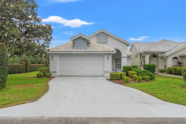 9188 Rhett Ln, Weeki Wachee, FL 34613 - mediterranean / spanish house with a front yard, an attached garage, stucco siding, and concrete driveway