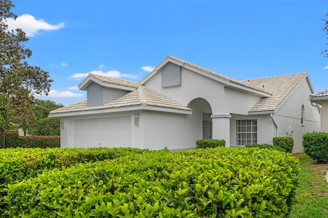 9188 Rhett Ln, Weeki Wachee, FL 34613 - mediterranean / spanish-style house with an attached garage and stucco siding