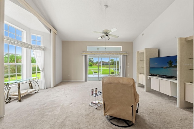 9188 Rhett Ln, Weeki Wachee, FL 34613 - living room featuring light carpet, plenty of natural light, and a ceiling fan