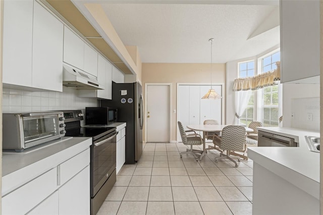9188 Rhett Ln, Weeki Wachee, FL 34613 - kitchen featuring under cabinet range hood, stainless steel appliances, white cabinetry, tasteful backsplash, and light tile patterned floors