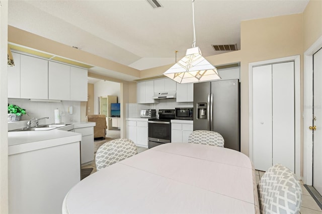 9188 Rhett Ln, Weeki Wachee, FL 34613 - kitchen featuring stainless steel appliances, under cabinet range hood, a sink, tasteful backsplash, and white cabinets