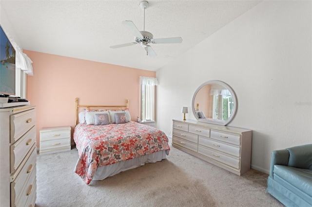 9188 Rhett Ln, Weeki Wachee, FL 34613 - bedroom with light carpet, multiple windows, lofted ceiling, a textured ceiling, and a ceiling fan
