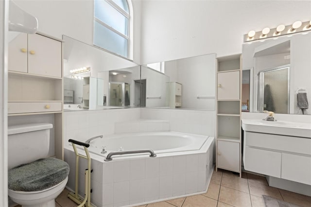 9188 Rhett Ln, Weeki Wachee, FL 34613 - full bathroom featuring a stall shower, toilet, a garden tub, tile patterned floors, and vanity