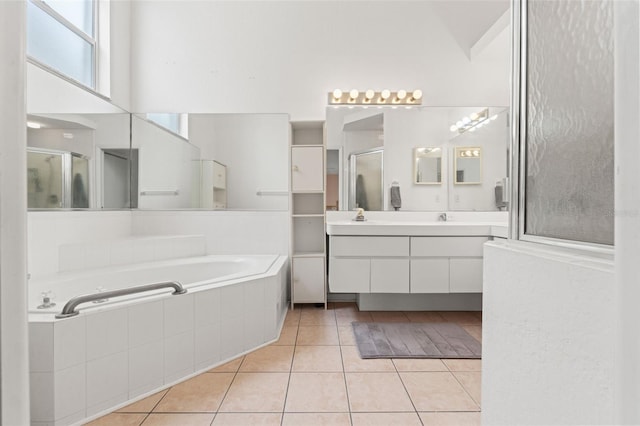 9188 Rhett Ln, Weeki Wachee, FL 34613 - full bathroom with tile patterned floors, a shower stall, a garden tub, and vanity