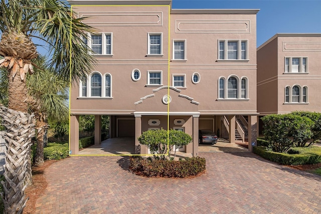 2750 Reserve Ct Unit 101, Dunedin, FL 34698 - view of front of home featuring stairs and decorative driveway