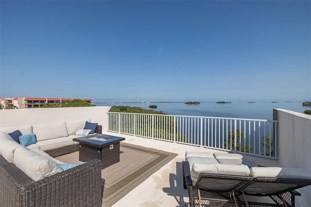 2750 Reserve Ct Unit 101, Dunedin, FL 34698 - view of patio featuring an outdoor living space with a fire pit and a water view