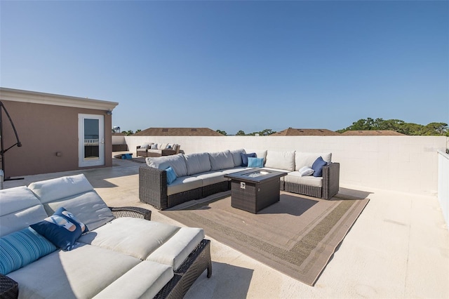2750 Reserve Ct Unit 101, Dunedin, FL 34698 - view of patio / terrace with an outdoor living space with a fire pit and fence