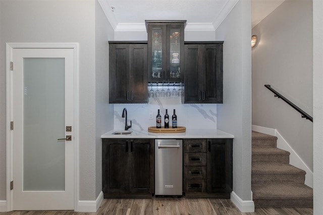 2750 Reserve Ct Unit 101, Dunedin, FL 34698 - indoor wet bar featuring ornamental molding, light wood-type flooring, baseboards, stairway, and backsplash