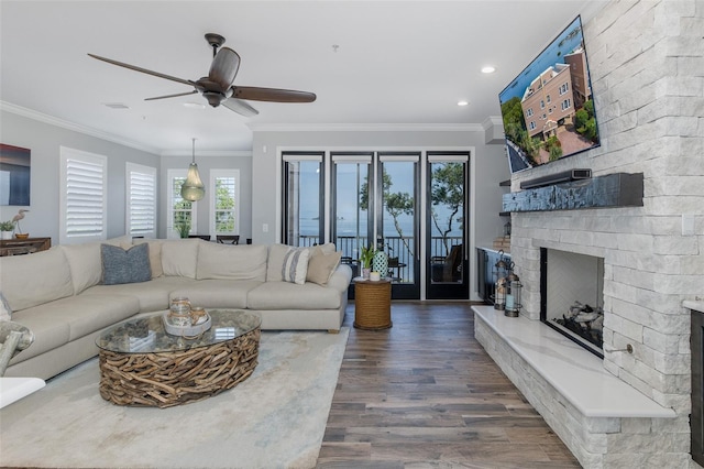 2750 Reserve Ct Unit 101, Dunedin, FL 34698 - living room featuring a fireplace, dark wood-type flooring, a ceiling fan, crown molding, and recessed lighting