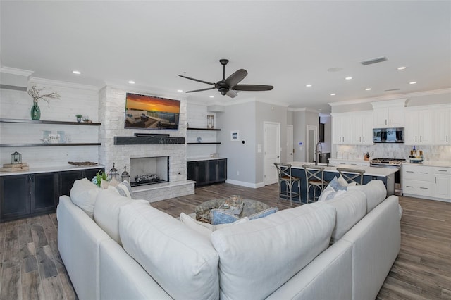 2750 Reserve Ct Unit 101, Dunedin, FL 34698 - living area featuring ceiling fan, dark wood-type flooring, baseboards, recessed lighting, and a stone fireplace