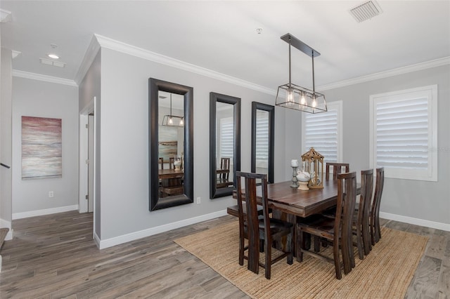 2750 Reserve Ct Unit 101, Dunedin, FL 34698 - dining space featuring wood finished floors, baseboards, ornamental molding, and recessed lighting