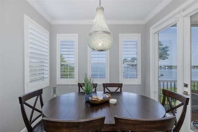 2750 Reserve Ct Unit 101, Dunedin, FL 34698 - dining area featuring ornamental molding and a chandelier