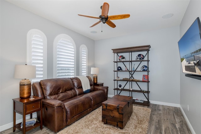 2750 Reserve Ct Unit 101, Dunedin, FL 34698 - living area with wood finished floors, ceiling fan, and baseboards