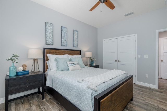 2750 Reserve Ct Unit 101, Dunedin, FL 34698 - bedroom featuring wood finished floors, baseboards, a closet, and a ceiling fan