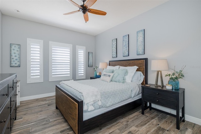 2750 Reserve Ct Unit 101, Dunedin, FL 34698 - bedroom with light wood-type flooring, baseboards, and ceiling fan