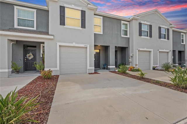32965 Kaloko Rd, Wesley Chapel, FL 33543 - view of property featuring a garage, stucco siding, and driveway