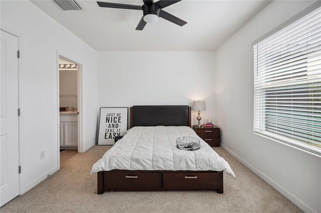 32965 Kaloko Rd, Wesley Chapel, FL 33543 - bedroom featuring light carpet, multiple windows, ensuite bathroom, and baseboards