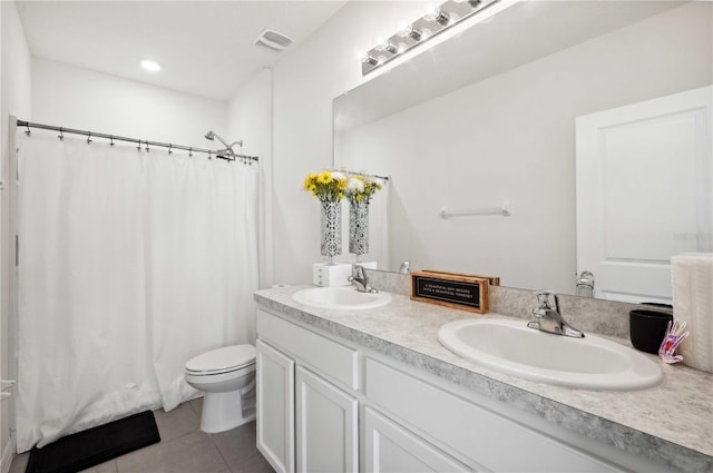 32965 Kaloko Rd, Wesley Chapel, FL 33543 - full bathroom featuring tile patterned floors, double vanity, toilet, and recessed lighting