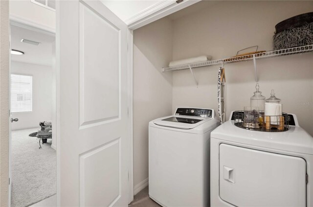 32965 Kaloko Rd, Wesley Chapel, FL 33543 - laundry room featuring washer and clothes dryer and carpet floors