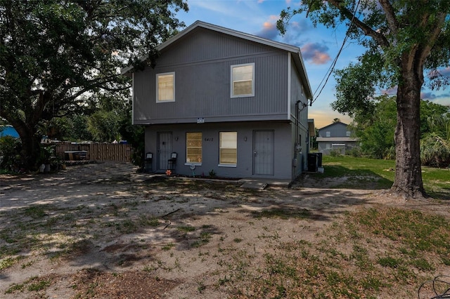 back of house with fence and central AC unit