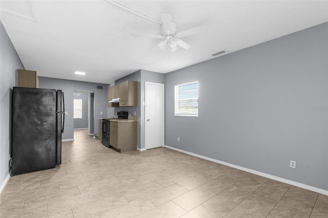 kitchen featuring black appliances, ceiling fan, baseboards, under cabinet range hood, and light countertops