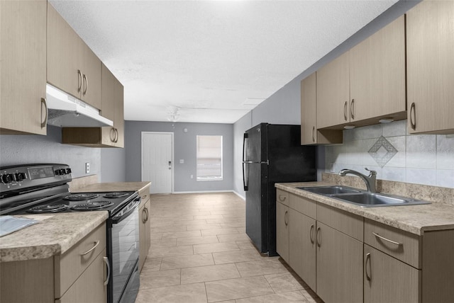 kitchen featuring black appliances, under cabinet range hood, a sink, tasteful backsplash, and light countertops