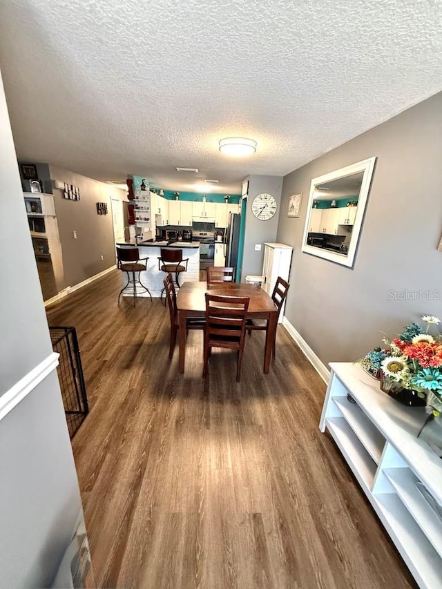 10411 Summerview Cir, Riverview, FL 33578 - dining room featuring dark wood-style flooring, baseboards, and a textured ceiling