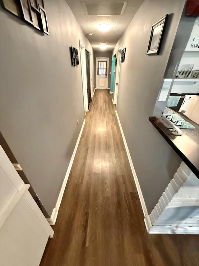 10411 Summerview Cir, Riverview, FL 33578 - hallway featuring wood finished floors, attic access, and baseboards