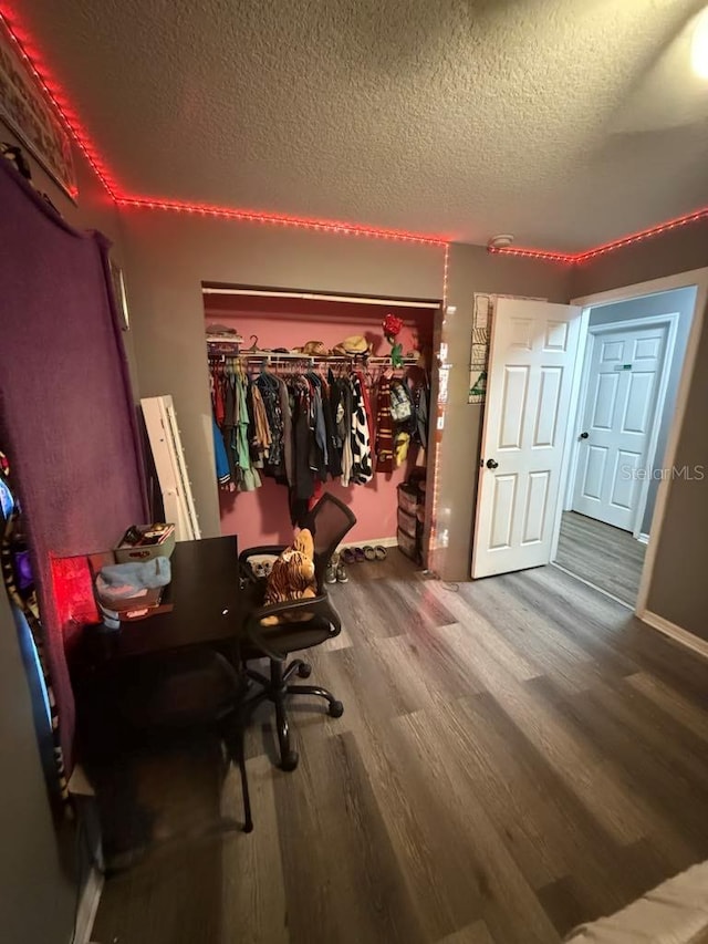 10411 Summerview Cir, Riverview, FL 33578 - bedroom with a textured ceiling, wood finished floors, baseboards, and a desk