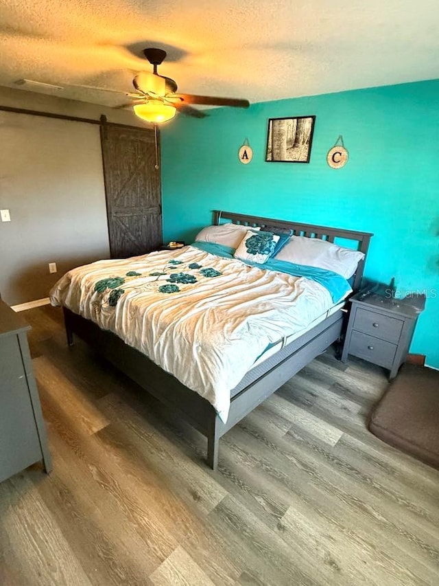 10411 Summerview Cir, Riverview, FL 33578 - bedroom featuring wood finished floors, a textured ceiling, ceiling fan, and baseboards