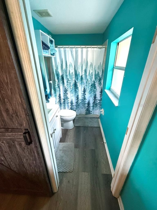 10411 Summerview Cir, Riverview, FL 33578 - full bathroom with wood finished floors, vanity, toilet, a shower with curtain, and baseboards