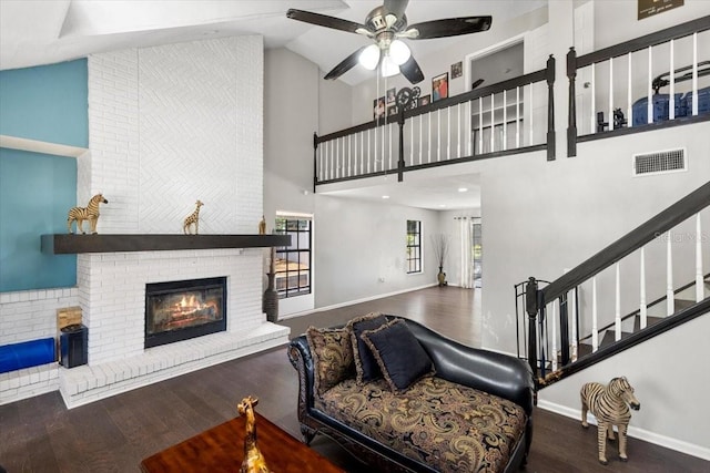 11207 Donneymoor Dr, Riverview, FL 33569 - living room featuring a fireplace, wood finished floors, a ceiling fan, high vaulted ceiling, and baseboards