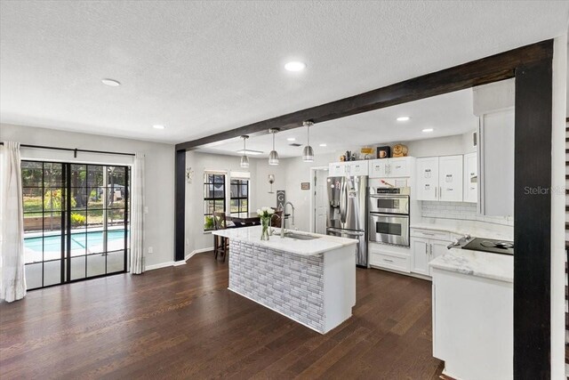11207 Donneymoor Dr, Riverview, FL 33569 - kitchen with stainless steel appliances, a textured ceiling, a sink, light countertops, and recessed lighting