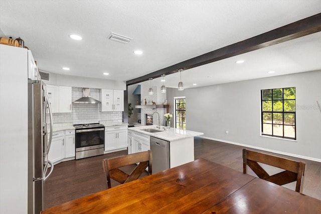11207 Donneymoor Dr, Riverview, FL 33569 - kitchen with stainless steel appliances, a sink, wall chimney range hood, dark wood-style floors, and beam ceiling