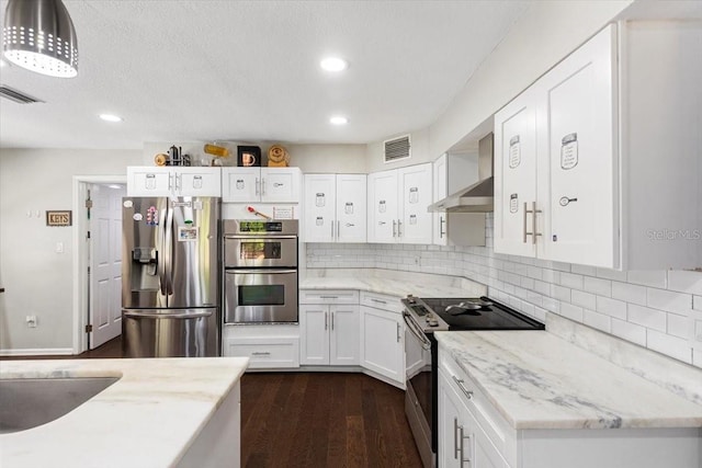 11207 Donneymoor Dr, Riverview, FL 33569 - kitchen featuring appliances with stainless steel finishes, wall chimney exhaust hood, white cabinetry, and recessed lighting