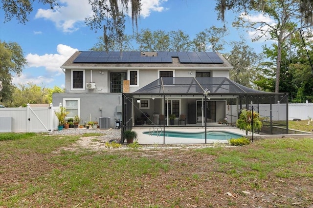 11207 Donneymoor Dr, Riverview, FL 33569 - back of house featuring a gate, solar panels, a patio area, central air condition unit, and stucco siding