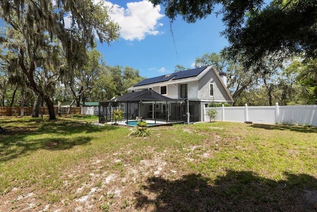 11207 Donneymoor Dr, Riverview, FL 33569 - rear view of house with roof mounted solar panels and a lanai
