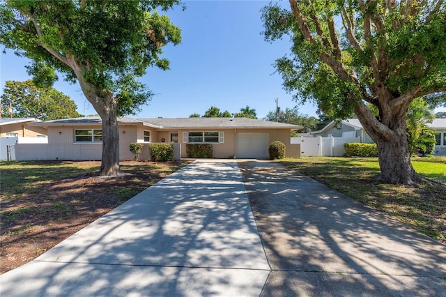 1400 63rd Ave S, Saint Petersburg, FL 33705 - ranch-style house with an attached garage, concrete driveway, and fence
